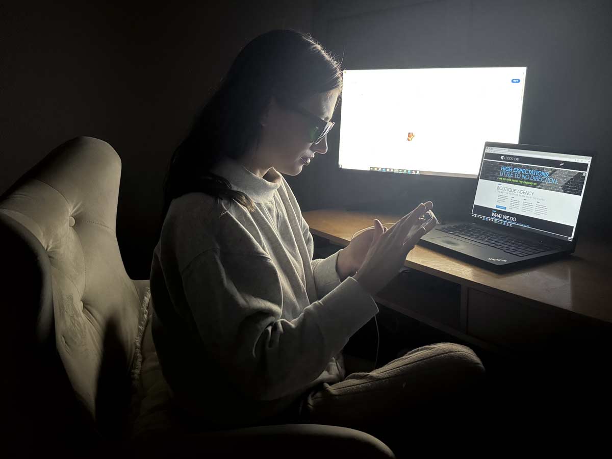 A woman avoids digital eyestrain by using nbGL glasses