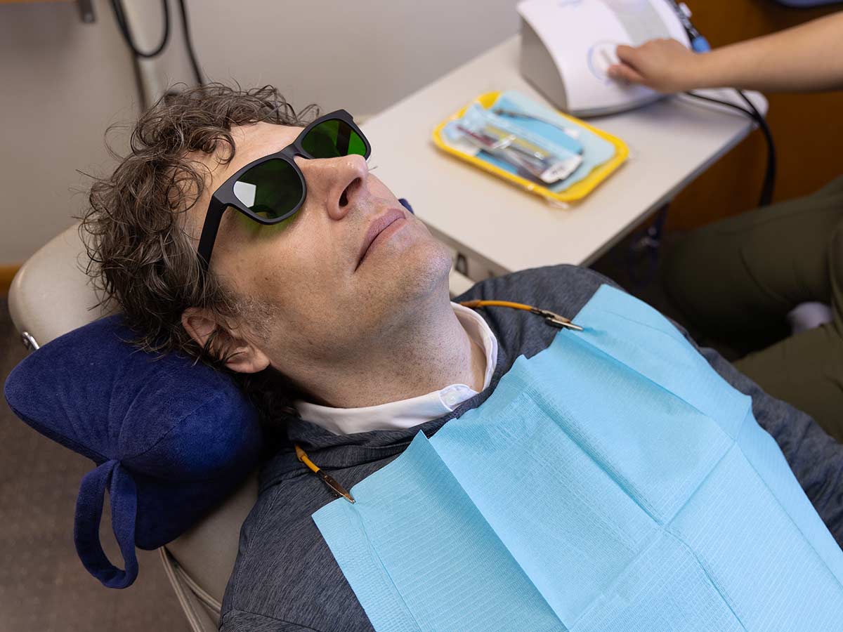 A patient wears nbGL glasses to reduce anxiety for a dental procedure.