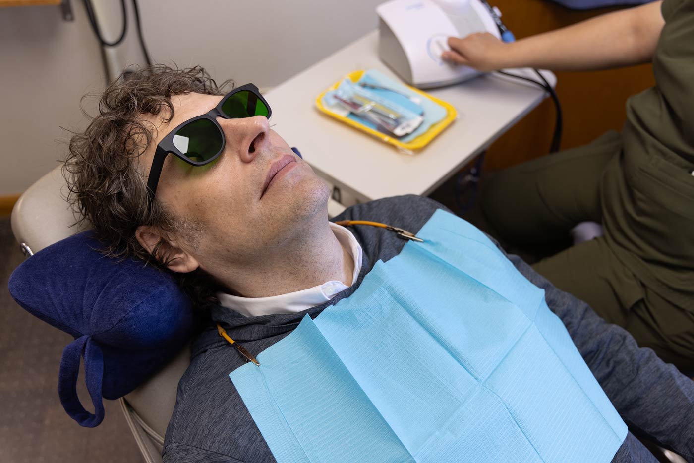 A patient wears nbGL glasses to reduce anxiety for a dental procedure.