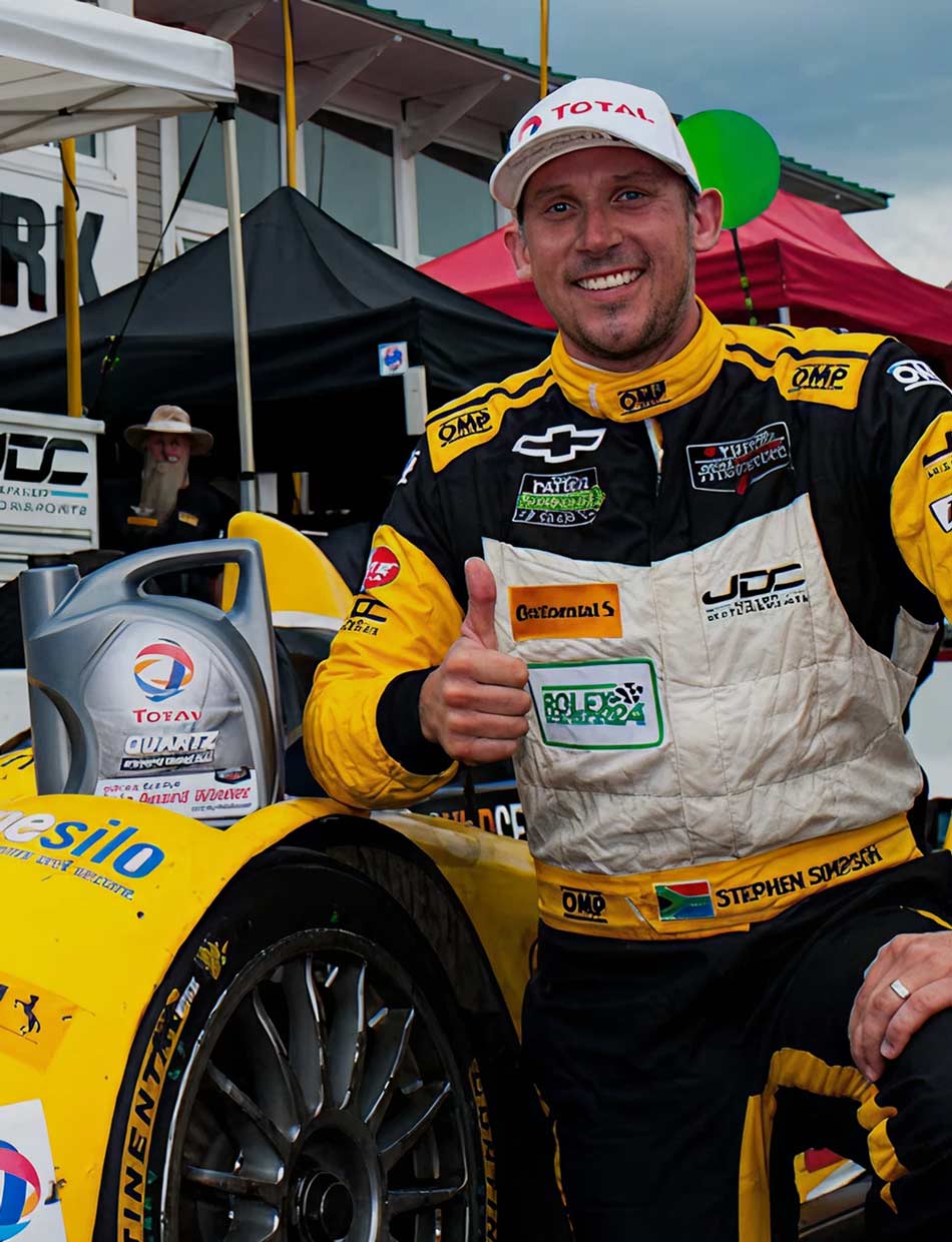 Race car driver Stephen Simpson poses with his car.